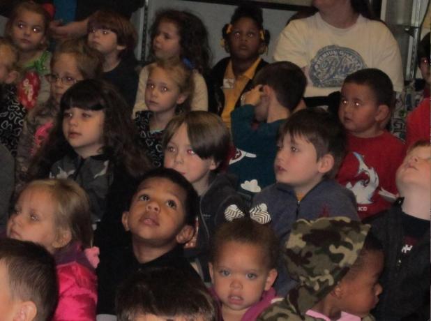	Nothing says “Christmas” more than the expressions on children’s faces. These Head Start students are shown listening to a Friends of the Library storytime during a 4-H Museum open house program on Dec. 6. {Photos by Raymond L. Daye}